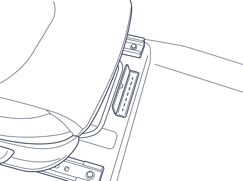The VIN stamped into the floor beside a front seat, with the small cover in the carpet folded open