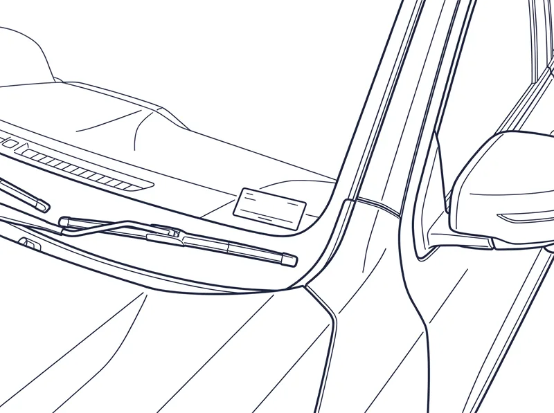 The VIN plate on top of the dashboard at the base of the windscreen on the passenger side, seen through the glass