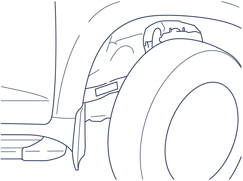 The VIN stamped into the chassis frame rail just behind the front right wheel, above the mud flap